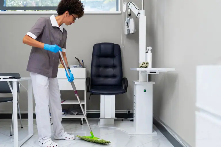 Medical office cleaning professional mopping clinic floor.