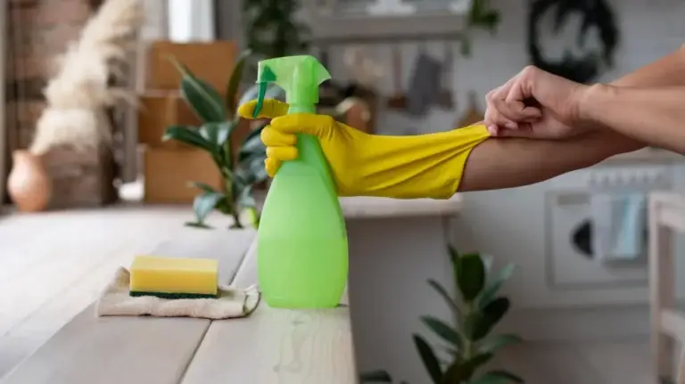 Hand putting on yellow cleaning glove