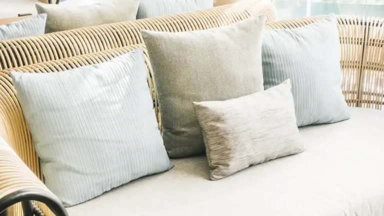 Rattan sofa decorated with soft throw pillows